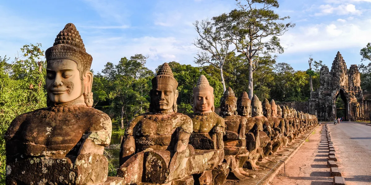 rs=w_1200,h_600,cg_true,m Angkor Thom stone statues line road.